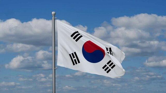 South Korea or Republic of Korea or ROK flag waying in the wind against the running clouds on blue sky, close-up flag video