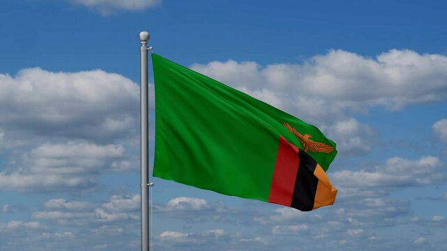 Zambia flag waying in the wind against the running clouds on blue sky, close-up flag video