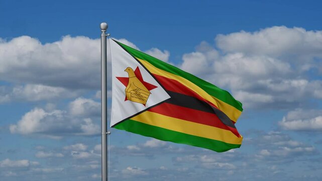 Zimbabwe flag waying in the wind against the running clouds on blue sky, close-up flag video