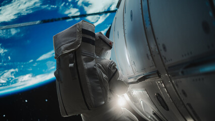 Astronaut on an Extravehicular Mission in Outer Space Far From Planet Earth. Courageous Man Holding by the Handle, Moving Outside the Space Station During a Service Procedure in Zero Gravity © Gorodenkoff