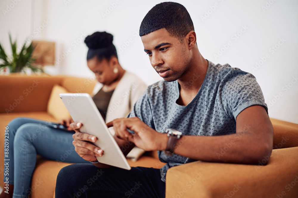 Poster man, relax and tablet on sofa in office for reading email, research and review feedback of project p