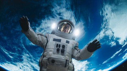 Obraz premium Portrait of Strong Female Astronaut Floating Outside a Spaceship with Planet Earth in the Background. Woman Waving to the Camera. Professional Spacewoman Posing in Her Space Suit, Smiling