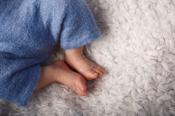 Newborn baby's feet on the background