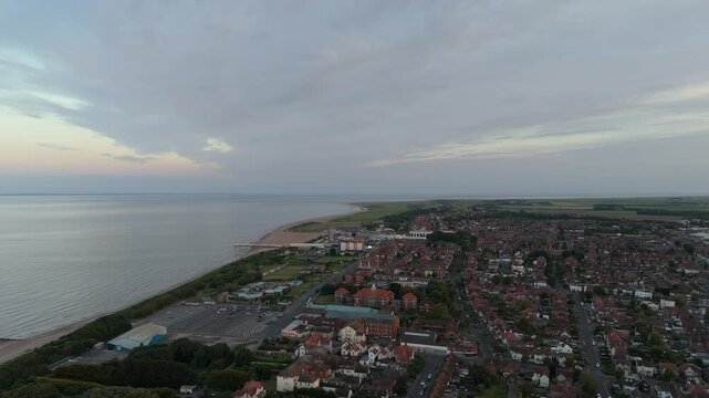 Coastal sunset on the popular seaside holiday resort of Skegness on the east coast of england. Warm summer tones and sweeping vista views.