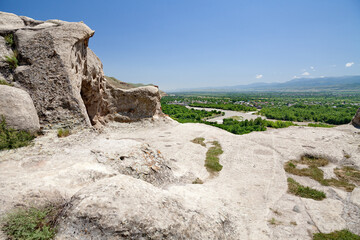 A view of Uplistsikhe cave town in Georgia. View of the Kura River. Mountainous landscape of Uplistsikhe. UNESCO site.