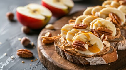 Toasts topped with peanut butter, apple slices, banana slices, nuts, and a drizzle of honey