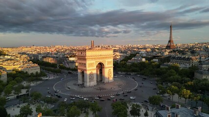Paris, Arc de Triomphe Triumphal Arch at Chaps Elysees at night, Paris, France. Drone view, Eiffel Tower in the background.  Architecture and landmarks of Paris. Postcard of Paris
