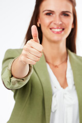 Happy woman, portrait and success with thumbs up for feedback, good review or well done on a white studio background. Young female person with smile, like emoji or yes sign for OK, great or thank you