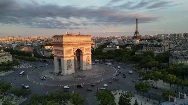 Paris, Arc de Triomphe Triumphal Arch at Chaps Elysees at night, Paris, France. Drone view, Eiffel Tower in the background.  Architecture and landmarks of Paris. Postcard of Paris
