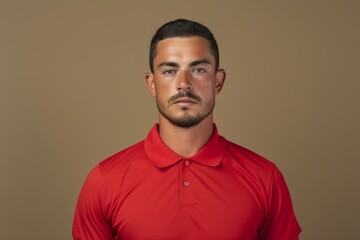 Fototapeta premium Portrait of a content man in his 30s wearing a breathable golf polo in blank studio backdrop