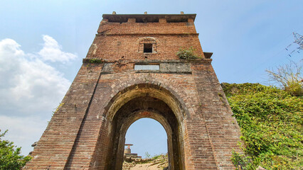 Obraz premium A Brick Watchtower At Hai Van Gate Area On Top Of Hai Van Mountain Pass, Vietnam. The Hai Van Gate Was Built On Hai Van Pass In 1826 To Protect The Hue Imperial Citadel.