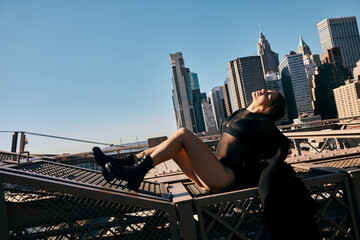 A young woman dances on a bridge in New York City.