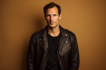 Obraz premium Portrait of a content man in his 40s sporting a vintage band t-shirt in front of light wood minimalistic setup