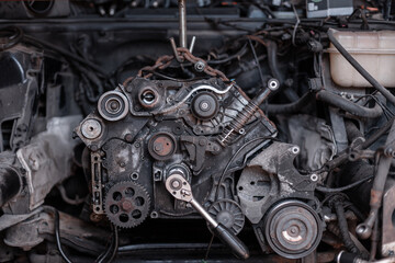 disassembled car with a broken V8 engine in the garage. engine and valve repair