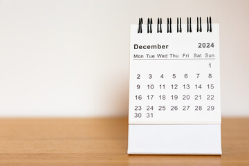 2024 calendar - December month page on the wooden desk