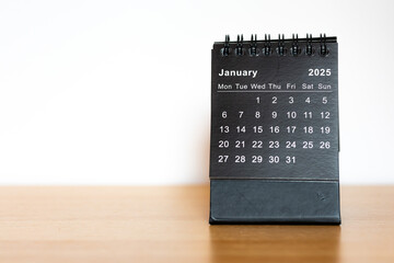 January 2025 calendar - month page on the wooden desk