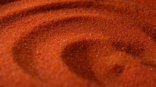 Small bright orange crystals of potassium dichromate, close up, abstract colorful background