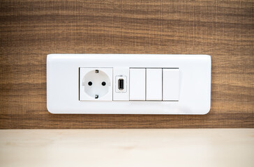 Modern Wall Electric Outlet and Switches Mounted on Wooden Background - Detail of Sophisticated Interior Design and Home Improvement Elements