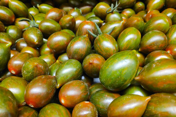 Stack of Tomato crispino plums on a market stall