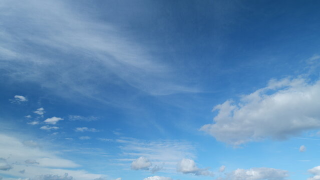 Sky with bautiful silky clouds. Puffy fluffy cumulus and cirrus on different layers clouds. Timelapse.