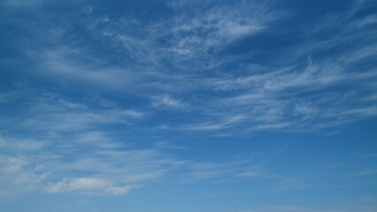 Blue sky with white cirrus clouds. Sunny background, blue sky with white cirrus clouds. Timelapse.