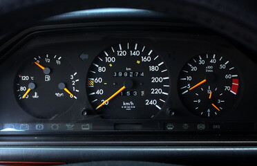 Old car speedometer with high mileage. Dashboard of oldschool car. Old car dashboard.