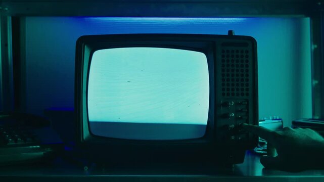 In a nostalgic setup, a retro TV displays static on its screen, reminiscent of an era gone by