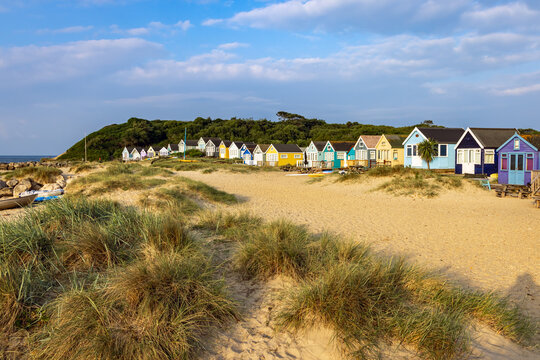 Vibrant Beach huts on Mudeford Spit in Dorset, England. Beach huts here are the most expensive in UK.