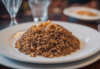 Mujadara with lentils, rice, and crispy onions on a white porcelain plate with a glass of Lebanese arak in a fine Lebanese restaurant
