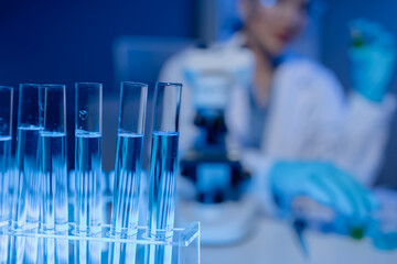 scientist is working on an important liquid inside tube in laboratory, the discovery of a vaccine to protect against currently spreading virus has been discovered, wear gloves and goggles for safety