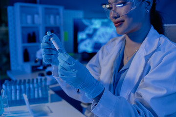 Fototapeta premium scientist is working on an important liquid inside tube in laboratory, the discovery of a vaccine to protect against currently spreading virus has been discovered, wear gloves and goggles for safety