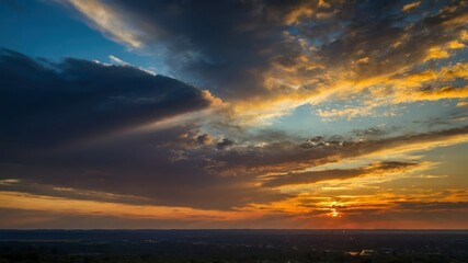 Fototapeta premium A stunning sunset over a vast landscape with dramatic clouds and vibrant colors, capturing the peaceful and serene atmosphere of twilight