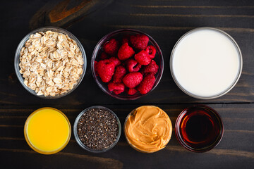 Raspberry Peanut Butter Oat Parfait Ingredients: Healthy breakfast parfaits with raspberries, rolled ots, fruit, and chia seeds in Irish coffee glasses