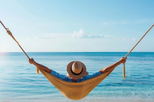 A person lounging in a hammock by the beach, representing ultimate relaxation - Powered by Adobe