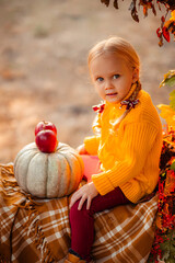 little girl with pumpkin
