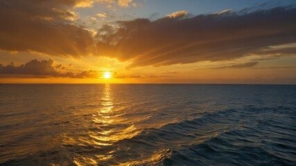 Obraz premium Breathtaking sunset over the ocean captures nature's beauty with golden sunlight reflecting on tranquil waves, perfect for serene and peaceful concepts