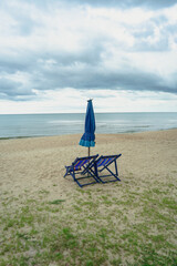 Beach bed ,canvas beds or trampoline with umbrellas in sea beach for tourists to rest on summer holiday with bright blue sky background at tropical island,Thailand.