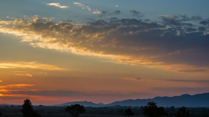 Fototapeta premium A serene sunset landscape with silhouetted mountains and a colorful sky, perfect for nature concepts, calm evening scenes, and scenic beauty