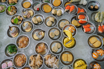 Yumcha, dim sum in bamboo steamer, Chinese cuisine. Variety of dim sum. A cozy dim sum set with a variety of dishes, ready to be enjoyed by diners