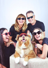 happy family with dog smiling all with sun glasses