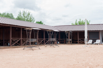 Shed with barbecues on the sandy beach. Holiday, summer weekend.