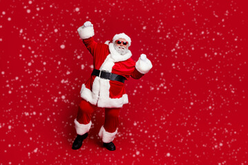 Full length body size view of attractive cheerful Santa dancing having fun rejoicing good mood isolated over bright red color background