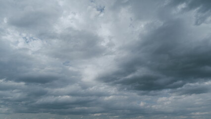 Fototapeta premium Sky with white fluffy rain clouds on the blue sky. Dramatic cloudscape, amazing sky. Timelapse.
