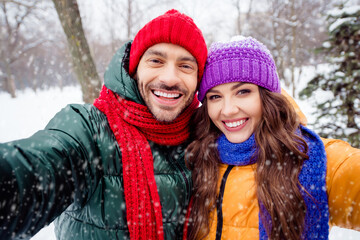 Fototapeta premium Photo of young cheerful couple happy positive smile shoot selfie winter vacation honeymoon walk park