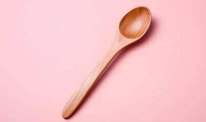 wooden spoon on a pink background