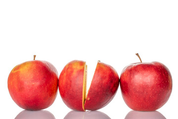 Two halves of a red apple and two whole, macro, isolated on white background.