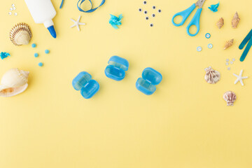 Adorable jellyfish made from plastic blue egg, Kids craft at home or kindergarten. Hands making DIY summer crafting with children. Ocean's day.