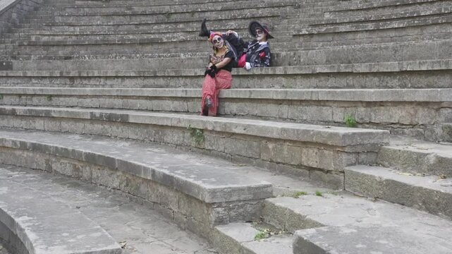 Catrina and Catrin Dancing Synchronously on Stone Steps. Day of the Dead.