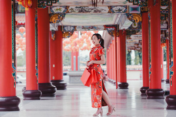 Naklejka premium Portrait beautiful woman in chines dress. woman in red dress. woman in red dress in Chinese temple 