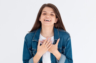 Hilarious joke. Portrait of happy optimistic girl with long hair in white shirt holding belly and laughing out loud, amused by silly funny anecdote